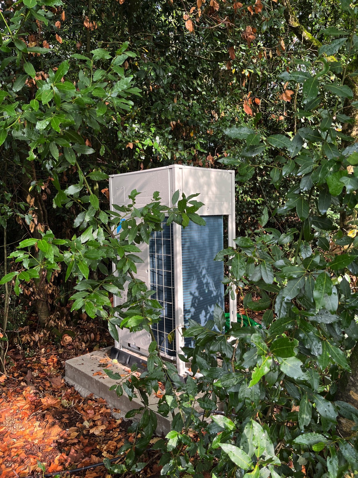 Groupe de la climatisation VRV Daikin caché dans le bois près du château à Portets